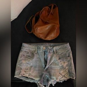 Genuine leather backpack with detailed lace pockets.